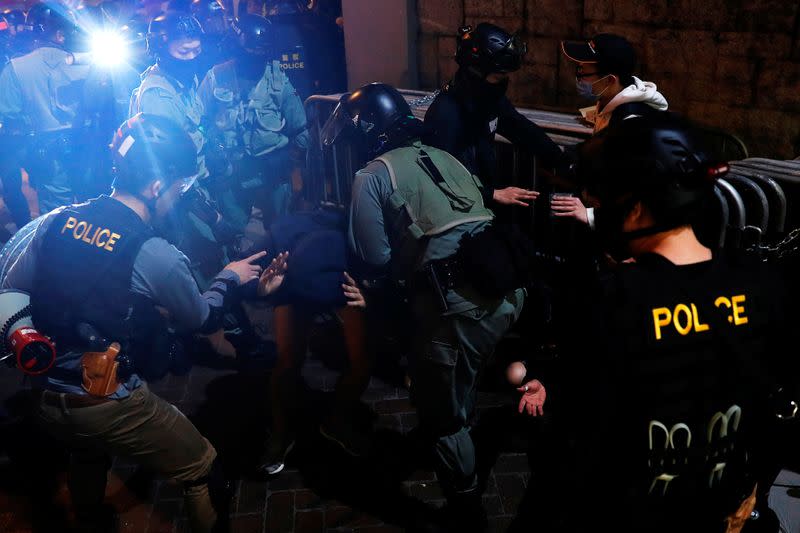 Riot police officers disperse anti-government protesters during a demonstration on New Year's Eve outside Mong Kok police station in Hong Kong