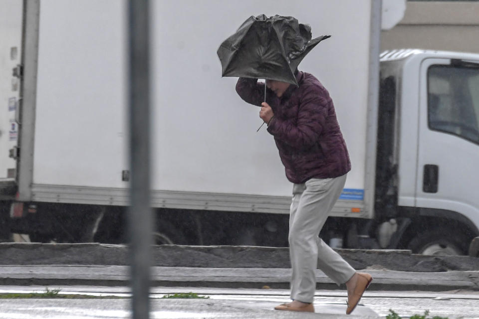 Commuters are seen as winter weather and large surf lashes Bondi Beach in Sydney in 2018. Southern parts of NSW are set for heavy winds with two cold fronts hitting later this week.