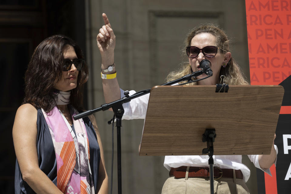 American biographer Amanda Foreman, right, and American journalist Andrea Elliot, left, speak during a reading event in solidarity with Salman Rushdie outside the New York Public Library, Friday, Aug. 19, 2022, in New York. (AP Photo/Yuki Iwamura)