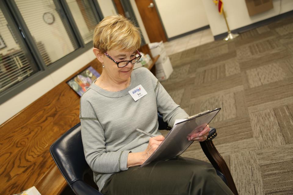 Long time election commission volunteer Ivy Prall directs traffic at the voting booths.