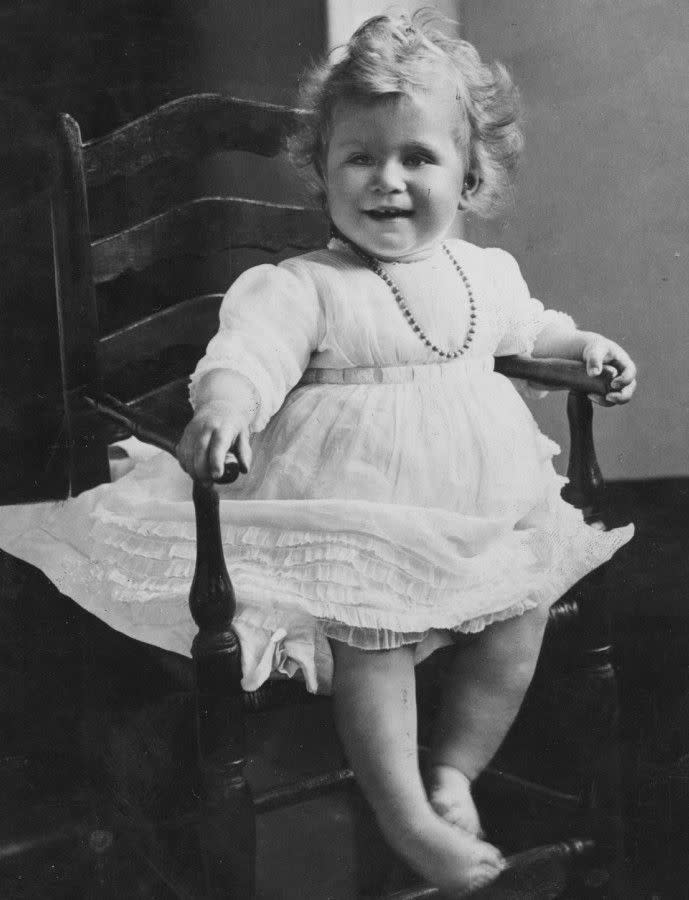 Fit to be queen! The future monarch smiles for a photographer in this early portrait, taken in 1927. Born in 1926, Elizabeth II was the first child of Britain's King George VI and his wife, Elizabeth.