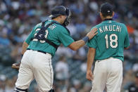 Seattle Mariners catcher Cal Raleigh, left, talks with starting pitcher Yusei Kikuchi during the fourth inning of the team's baseball game against the Oakland Athletics, Friday, July 23, 2021, in Seattle. (AP Photo/Ted S. Warren)