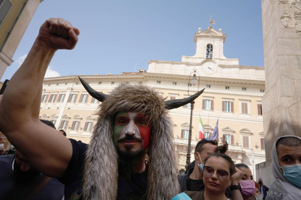 Demonstrators gather outside the lower Chamber during a protest by Restaurant and shop owners in Rome, Tuesday, April 6, 2021. Demonstrators demanded to reopen their business and protested against restrictive measures by the Italian Government to cope with the surge of COVID-19 cases. (AP Photo/Andrew Medichini)