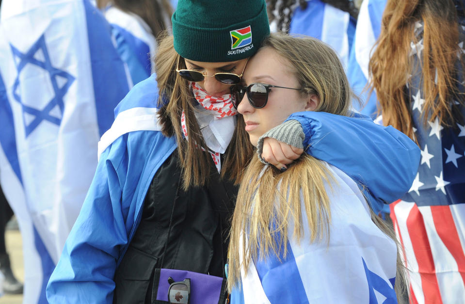 <p>Two participants of the yearly March of the Living hug each other in the former German Nazi Death Camp Auschwitz-Birkenau, in Brzezinka, Poland, Monday, April 24, 2017. Jews from Israel and around the world marched the 3km route from Auschwitz to Birkenau commemorating the Holocaust victims. (AP Photo/Alik Keplicz) </p>