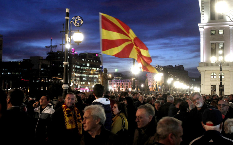 People gather for a protest march organized by the opposition conservative VMRO-DPMNE party, starting outside the Public Prosecutor's office and ending in front of the complex of national courts, in Skopje, North Macedonia, Tuesday, Feb. 25, 2020. Thousands of conservative opposition party supporters were marching in North Macedonia's capital Skopje late on Tuesday, accusing the outgoing leftist government for strongly influencing prosecution and court decisions. (AP Photo/Boris Grdanoski)