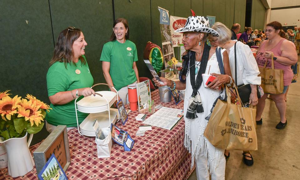 Brenda Wilkins of Anderson, right, visits the Dominion Senior Care booth with Jennifer Stewart, left, and Hazel Miller, middle, during the 9th Annual Golden Years Jamboree at the Anderson Sports & Entertainment Complex in Anderson, SC, Wednesday , July 17, 2024.