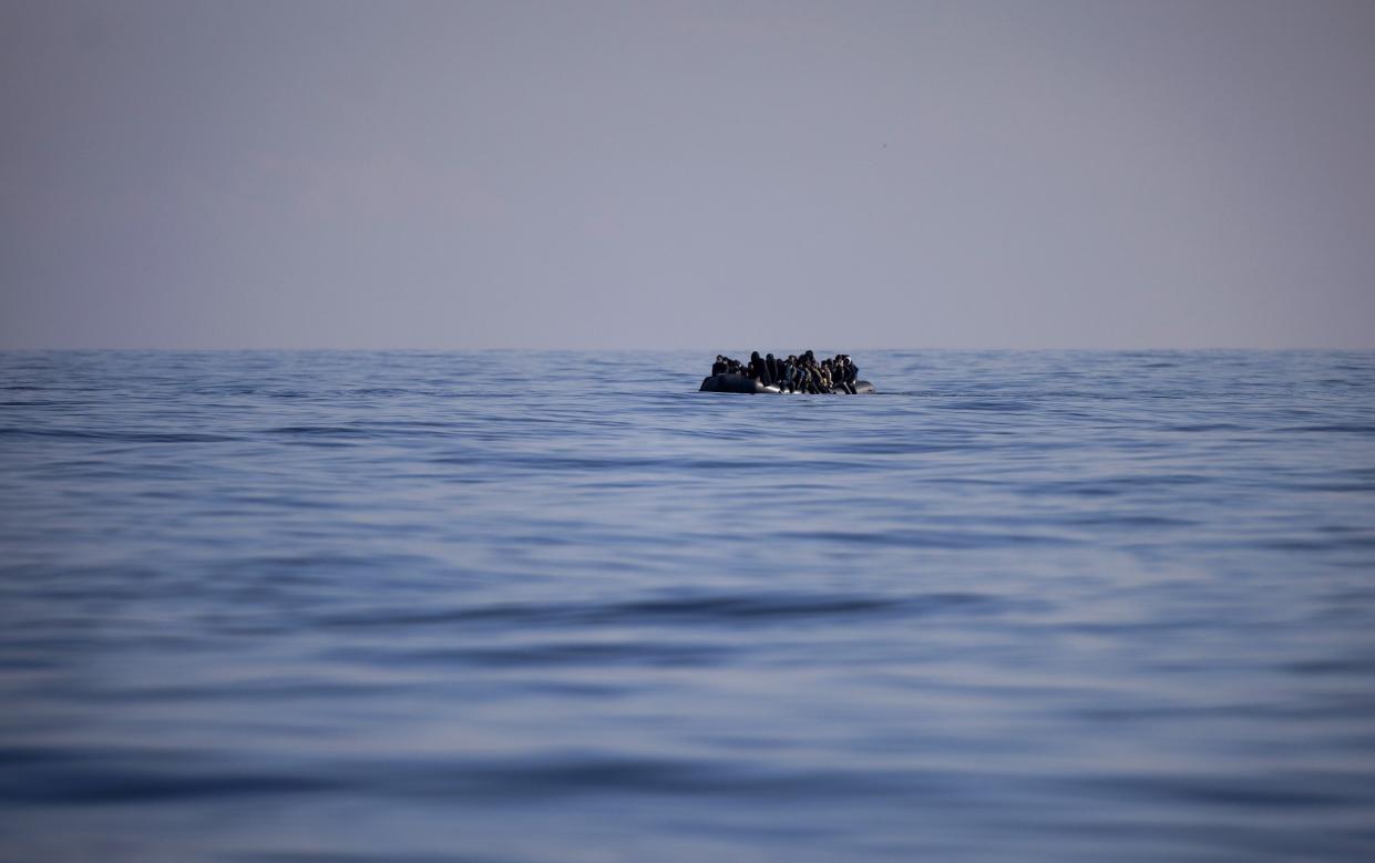 An inflatable dinghy carrying migrants crosses the English Channel