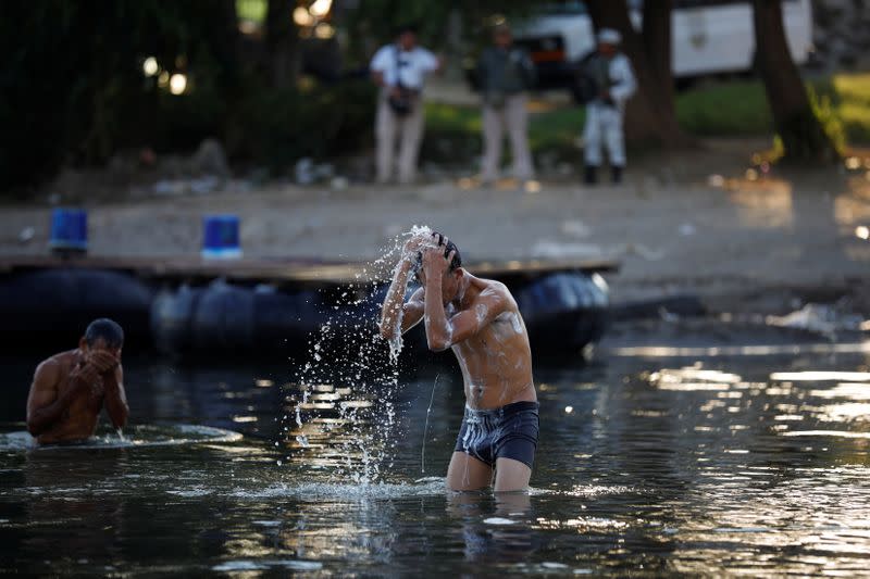 Migrant travelling to the U.S. take a bath in the Suchiate river at the border between Guatemala and Mexico, in Tecun Uman