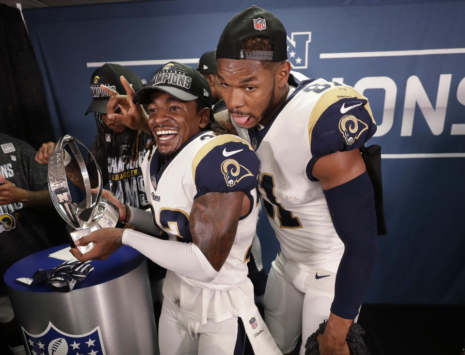 Los Angeles Rams defensive back Nickell Robey-Coleman (23) and Los Angeles Rams tight end Gerald Everett (81) celebrate in the locker room after overtime of the NFL football NFC championship game, against the New Orleans Saints, Sunday, Jan. 20, 2019, in New Orleans. The Rams won 26-23. (AP Photo/David J. Phillip)