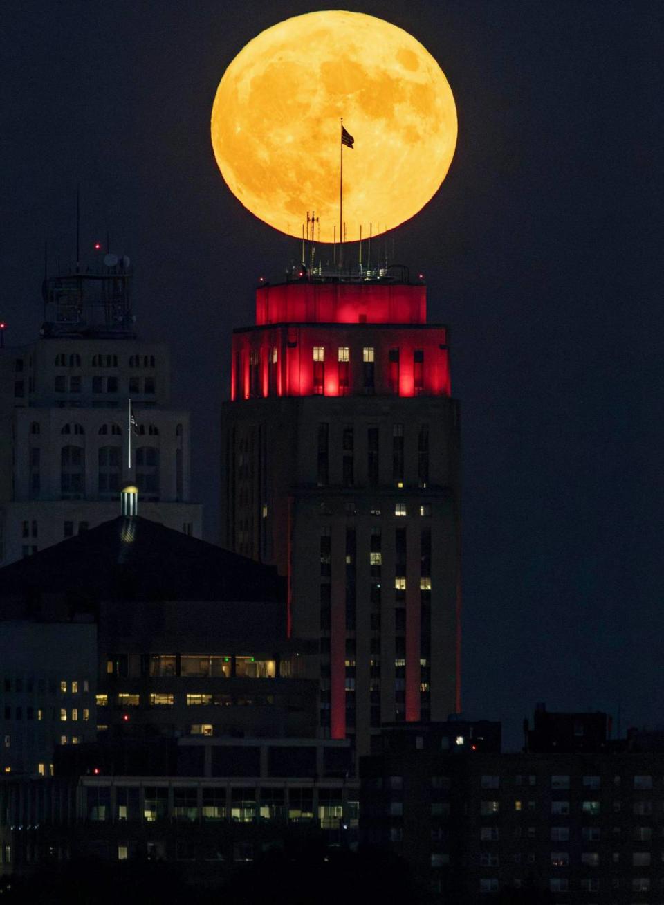 The flag atop city hall in downtown Kansas City was silhouetted against the rising super blue moon Wednesday night.