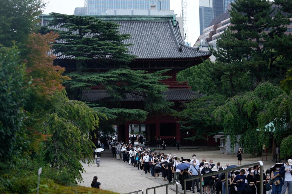 People wait in line to pay their respects to the former Japanese prime minister prior to his funeral (AP)