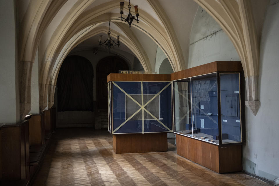 Cabinets in a hallway of the Museum of the History of Religion sit empty in Lviv, western Ukraine, Friday, March 4, 2022. Workers are assembling metal containers in the patio at the museum to safely store the remaining items before placing them in basements in case the Russian invasion advances west. (AP Photo/Bernat Armangue)