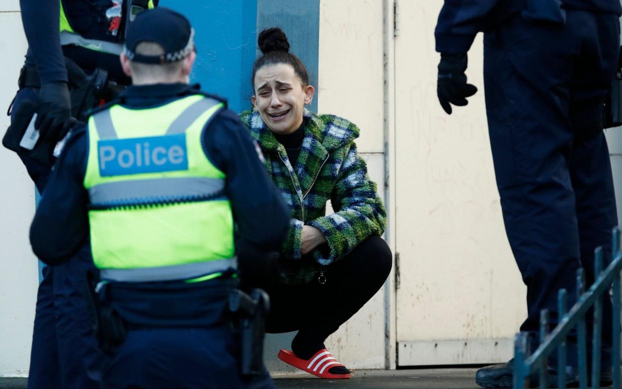 A resident pleads with police after attempting to leave public housing towers on Racecourse Road in Flemington, Melbourne - DANIEL POCKETT/EPA-EFE/Shutterstock