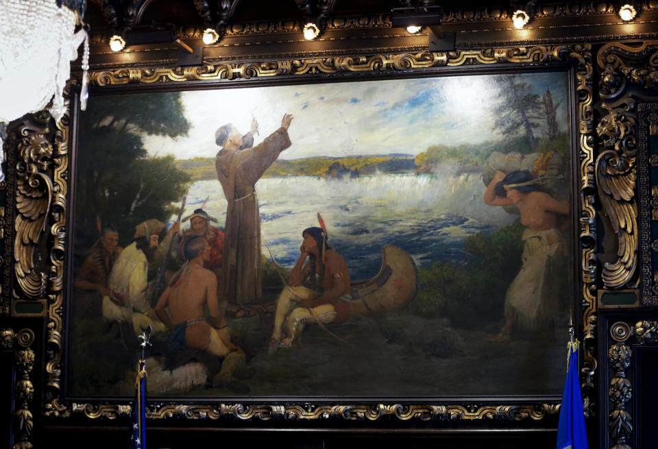 In this March 6, 2014 photo, a painting by Douglas Volk depicts" Father Hennepin at the Falls of St. Anthony" in the governor's reception room at the Minnesota State Capitol in St. Paul, Minn. Beginning in the spring, work crews will take down paintings and sculpture and cover murals and statues as the renovation continues on the century old building. (AP Photo/Jim Mone)