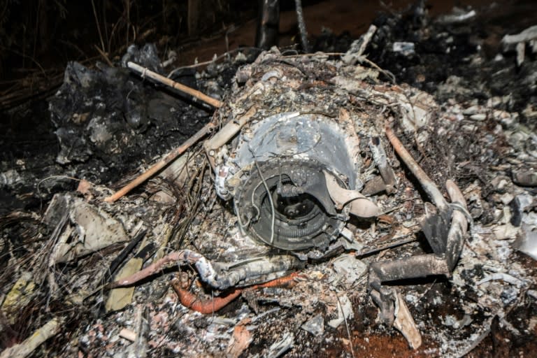 The remains of the plane's burned fuselage are seen