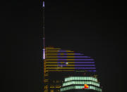 The Wilshire Grand Center, a 1,100-foot (335.3 m) skyscraper top floors' lighting showcases Los Angeles Lakers Kobe Bryant's vintage number 8, downtown Los Angeles, Sunday night, Jan. 26, 2020. NBA retired player Bryant, his 13-year-old daughter and several others are dead after their helicopter went down in Southern California. The chopper crashed Sunday in Calabasas, about 30 miles northwest of downtown Los Angeles. (AP Photo/Damian Dovarganes)