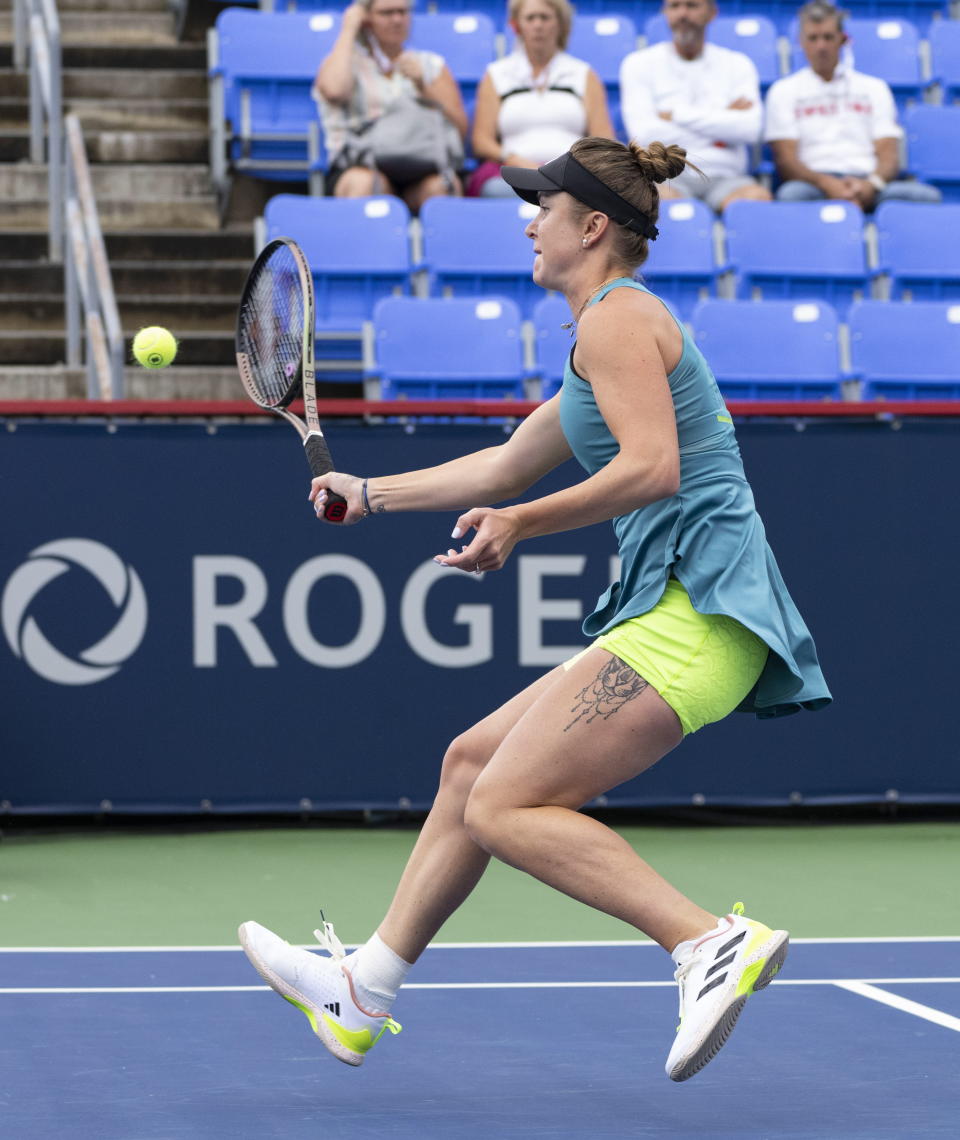 Elina Svitolina, of Ukraine, hits a return to Danielle Collins during the National Bank Open tennis tournament in Montreal, Tuesday, Aug. 8, 2023. (Christinne Muschi/The Canadian Press via AP)