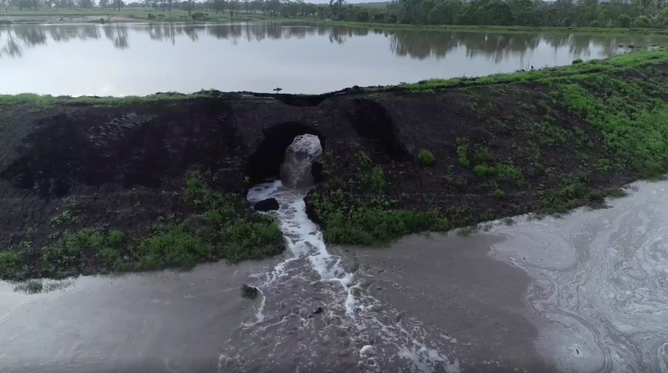 Bolzan Quarry Dam is pictured with water gushing out.