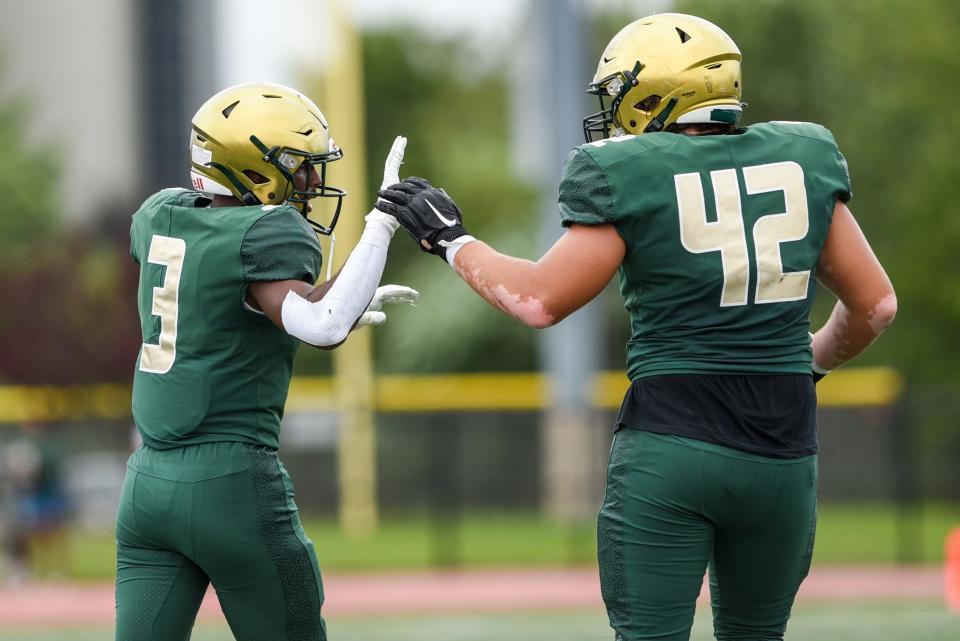 St. Joseph opens its football season by hosting Maryland's Our Lady of Good Counsel at Overpeck County Park in Palisades Park on Saturday August 28, 2021. SJ #3 Trey Watkins and SJ #42 James Mullen high five one another. 