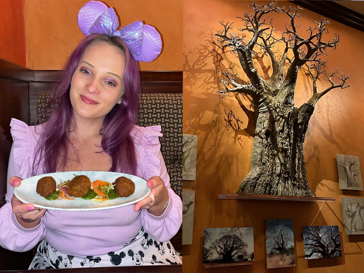 Author wearing purple outfit and holding falafel platter. Tree of Life miniature sculpture hanging on wall surrounded by small paintings.