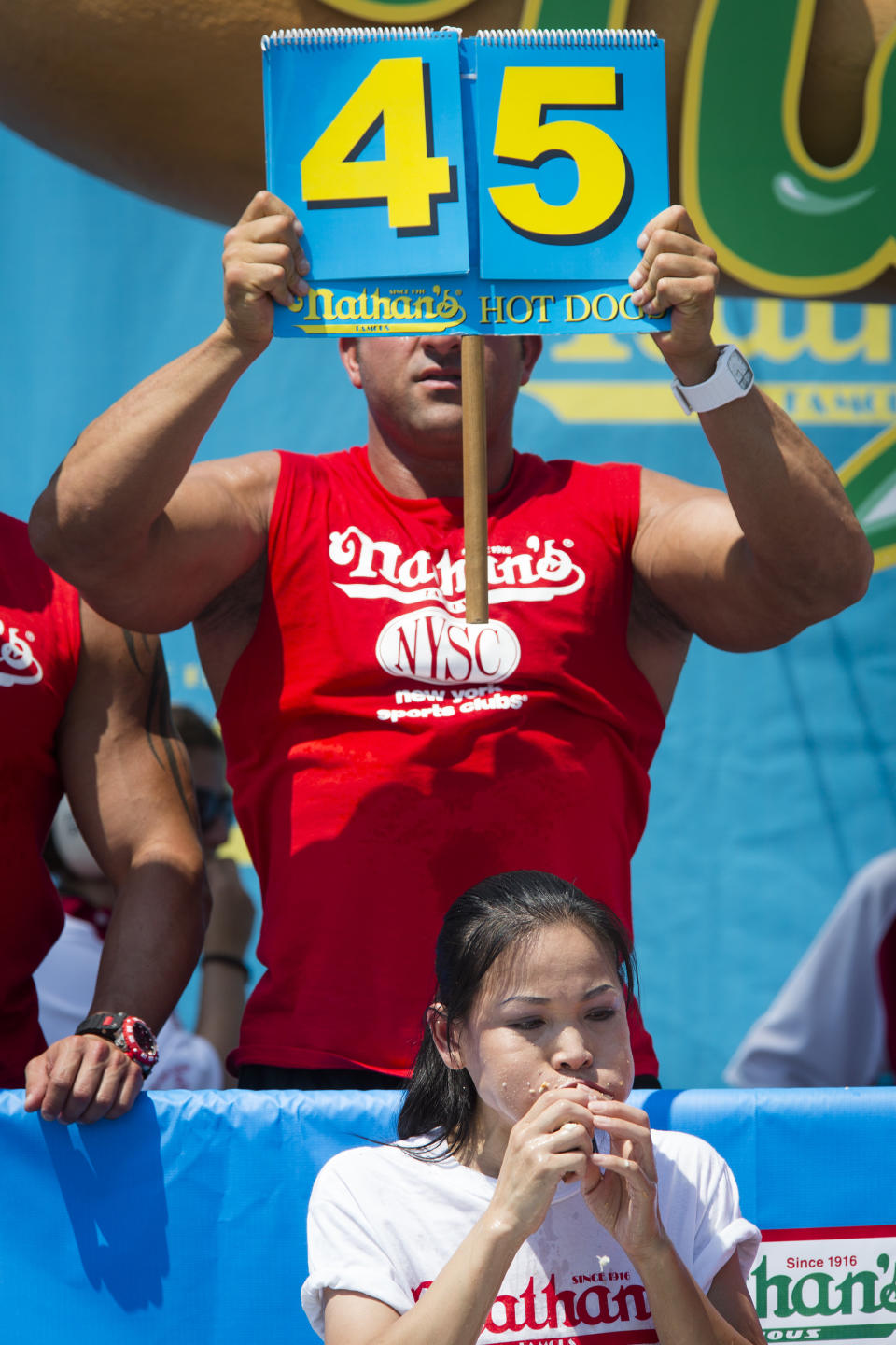 Sonya "The Black Widow" Thomas breaks her world record during the Nathan's Famous Women's Hot Dog Eating World Championship, Wednesday, July 4, 2012, at Coney Island, in the Brooklyn borough of New York. Thomas beat her own record by gobbling down 45 hot dogs and buns in 10 minutes to win the women's competition at the annual Coney Island contest. (AP Photo/John Minchillo)