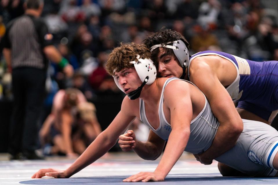 Fort Collins' Cam Soto (top) holds on to Poudre's Brett Lamb in a 5th place match during at the Colorado state wrestling tournament at Ball Arena on Saturday, Feb. 18, 2023 in Denver, Colo.