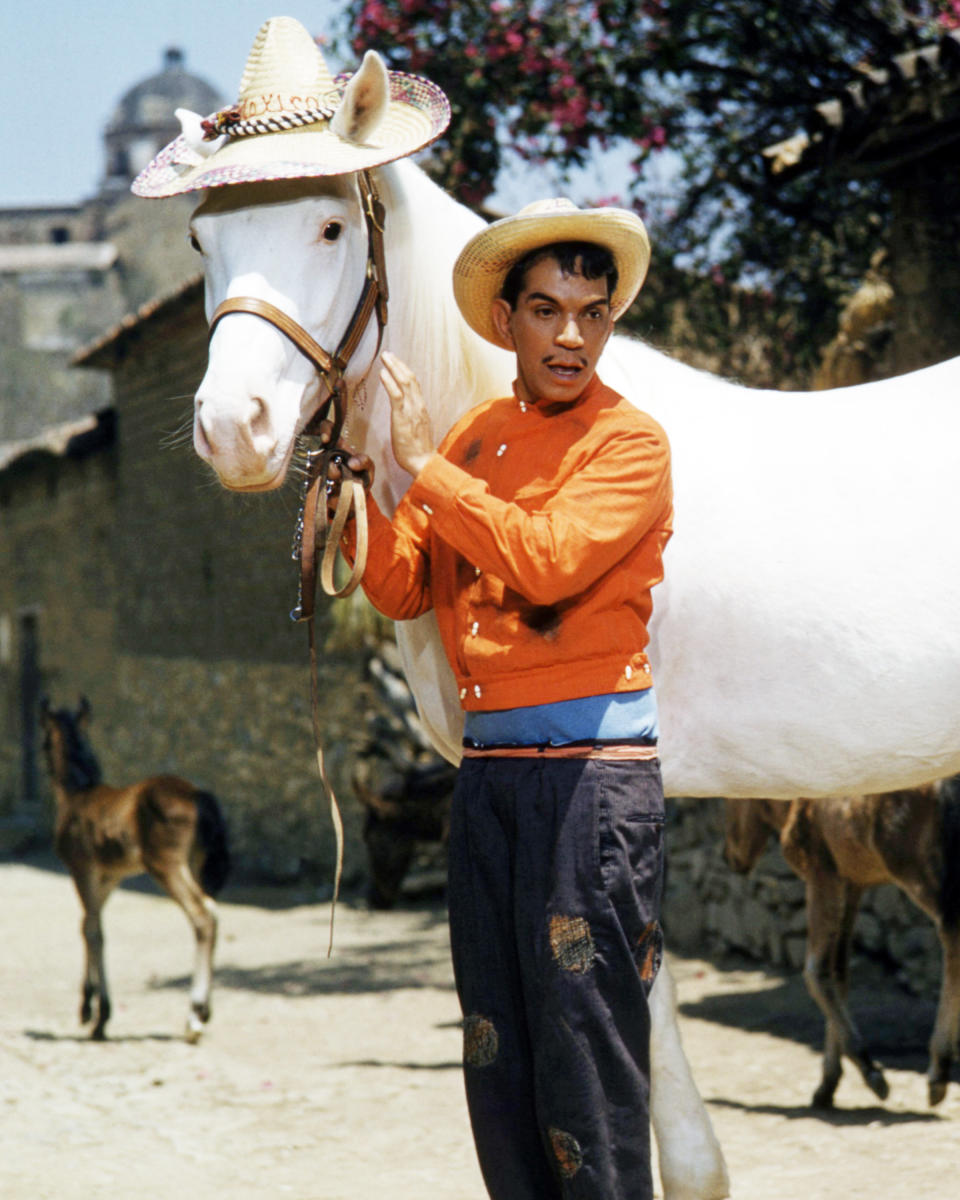 Mexican actor and comedian Cantinflas (1911 - 1993, left), with a white horse wearing a straw hat, in 'Pepe', directed by George Sidney, 1960. Cantinflas plays the title role in the film. (Photo by Silver Screen Collection/Getty Images)