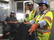 This Aug. 20, 2019, image shows employees with Peabody Energy and the Navajo Generating Station talking about the pending closure of the mine and power plant during a tour of a coal silo near Kayenta, Ariz. The Navajo Generating Station near Page, Arizona, will close before the year ends and other coal-fired plants in the region are on track to shut down or reduce their output in the next few years. (AP Photo/Susan Montoya Bryan)