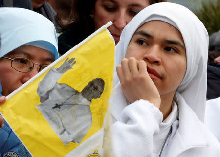 A nun looks on as she waits for the arrival of Pope Francis in Pietrelcina, Italy March 17 2018. REUTERS/Ciro De Luca