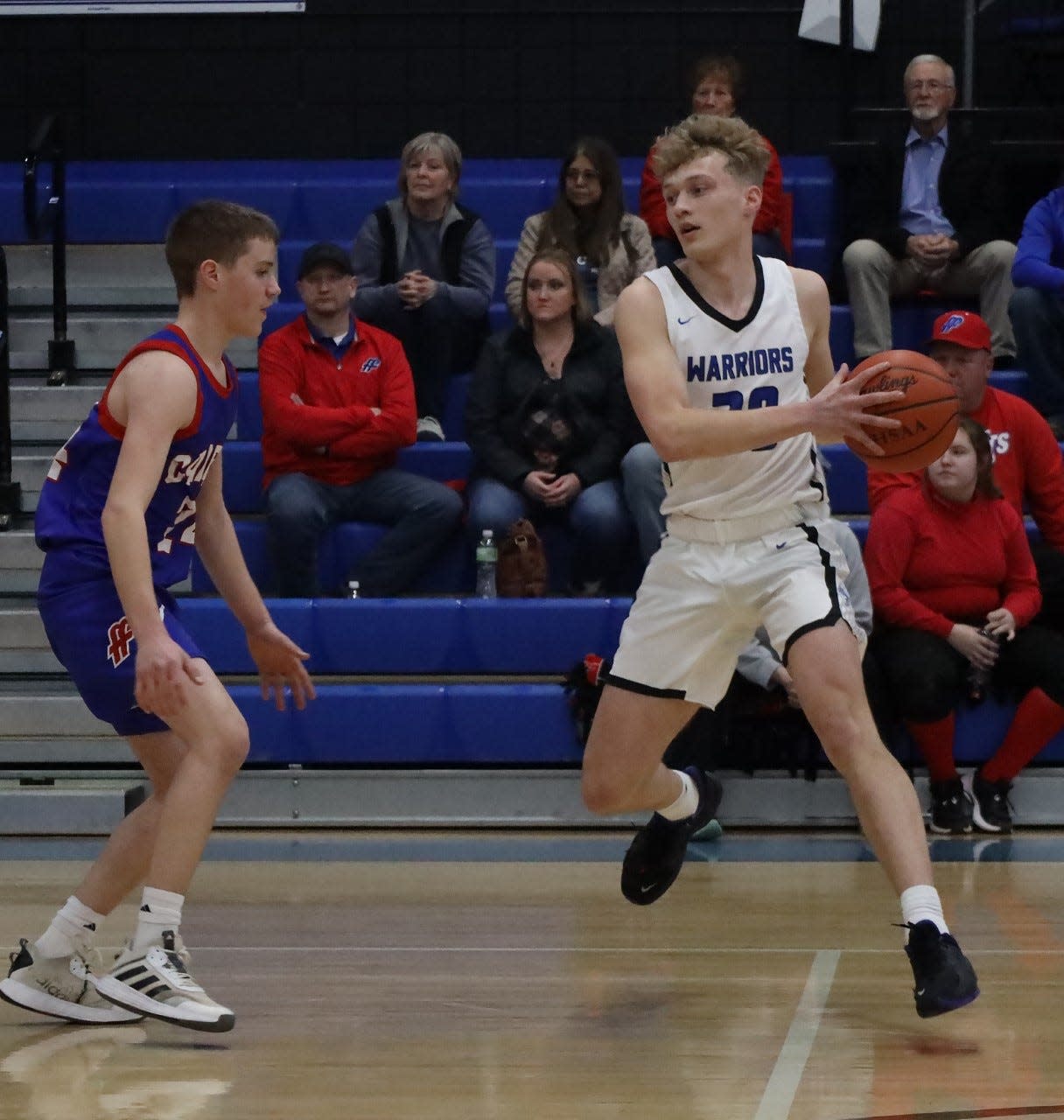 Buckeye Trail junior Donovan Geiger (20) protects the ball from Fort Frye's Zach Huffman (24) during Friday's OVAC contest in Old Washington. Trail collected a 52-42 victory to improve to 13-7 on the season.