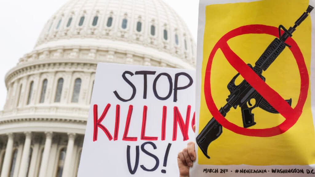 Demonstrators hold signs during a rally with senators outside the U.S. Capitol to demand the Senate take action on gun safety on Thursday, May 26, 2022, in the wake of the Robb Elementary School shooting in Texas. (Tom Williams/CQ-Roll Call, Inc via Getty Images)