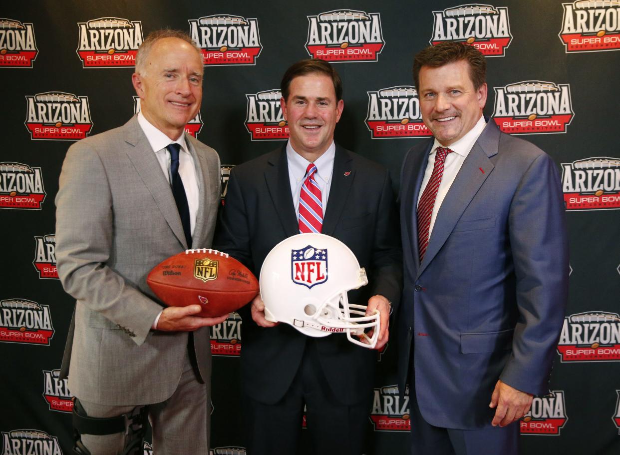 Arizona Super Bowl Host Committee Chairman David Rousseau (left), Arizona Governor Doug Ducey (center) and Cardinals President Michael Bidwill, pose for photos after a press conference on Arizona's selection as the host for Super Bowl LVII in 2023 at the Sanctuary Resort in Scottsdale May 23, 2018.