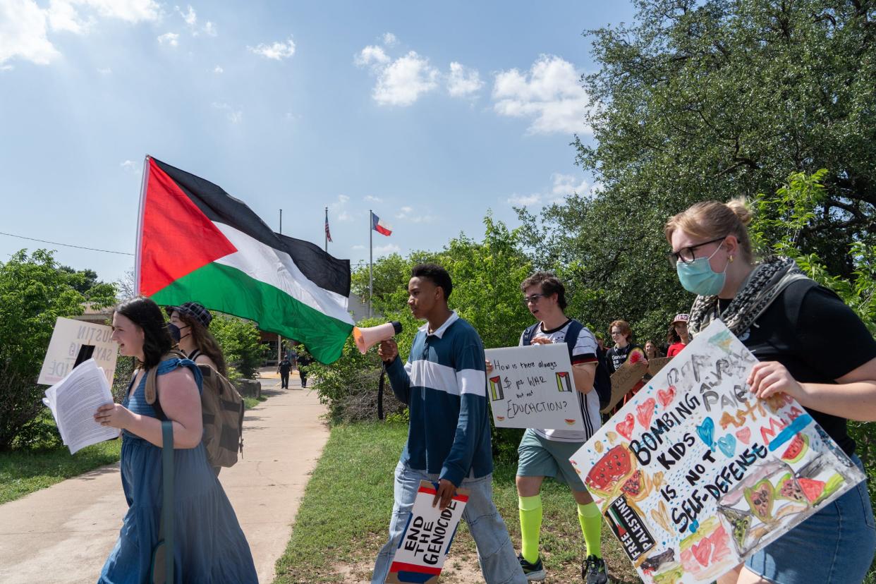 Students participate in a walk-out during a pro-Palestenian protest at McCallum High School Monday, April 29, 2024.