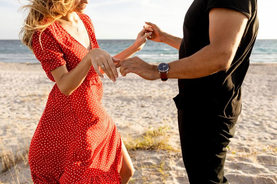close up mans and womans hand fell in love spending time near the sea happy young boyfriend and girlfriend having fun at beach on sunset travel and freedom concept back to normal