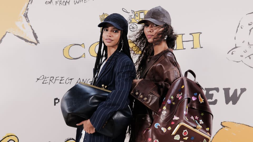 Coach played with scale this season, turning coin purses into weekender bags. Pinstripe trenches, weathered leather jackets and other classic Coach outerwear was given a youthful makeover, paired with satin mini dresses, stickered backpacks and retro sneaker accessories. - Ben Rosser/BFA.com