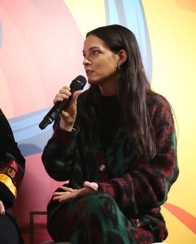 <p>Natasha Campos/Getty</p> Riley Keough speaks during a panel at Indigenous House: Sundance Film Festival 2024.