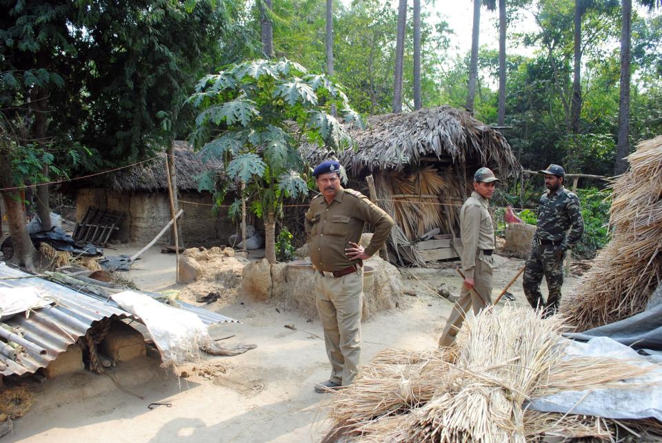 Policemen inspect the site where a woman was gang raped, allegedly on the direction of a village council at Subalpur village, in Birbhum district, about 180 kilometers (110 miles) north of Kolkata, the capital of the eastern Indian state of West Bengal, Friday, Jan. 24, 2014. The woman told police that Monday's attack came as punishment for falling in love with a man from a different community and religion. The case has brought fresh scrutiny to the role of village councils, common in rural Indian, which decide on social norms in the village. (AP Photo)