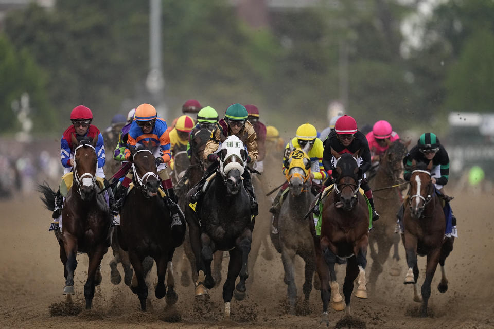 CORRECTS TO REMOVE REFERENCE TO FINISH LINE TO WIN - Brian Hernandez Jr. rides Mystik Dan, right, as horses near the first turn during the 150th running of the Kentucky Derby horse race at Churchill Downs on Saturday, May 4, 2024, in Louisville, Ky. Mystic Dan went on to win the race. (AP Photo/Brynn Anderson)