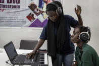 Aminata "Myamy TheAyGirl" Thiam, 31years - Old, left, instructs a student 30 years old Julia Sall, at a beat making class for women in Dakar, Senegal, Wednesday, Aug. 14, 2024. Aminata Thiam is Senegal's first female beatmaker. (AP Photo/Annika Hammerschlag)