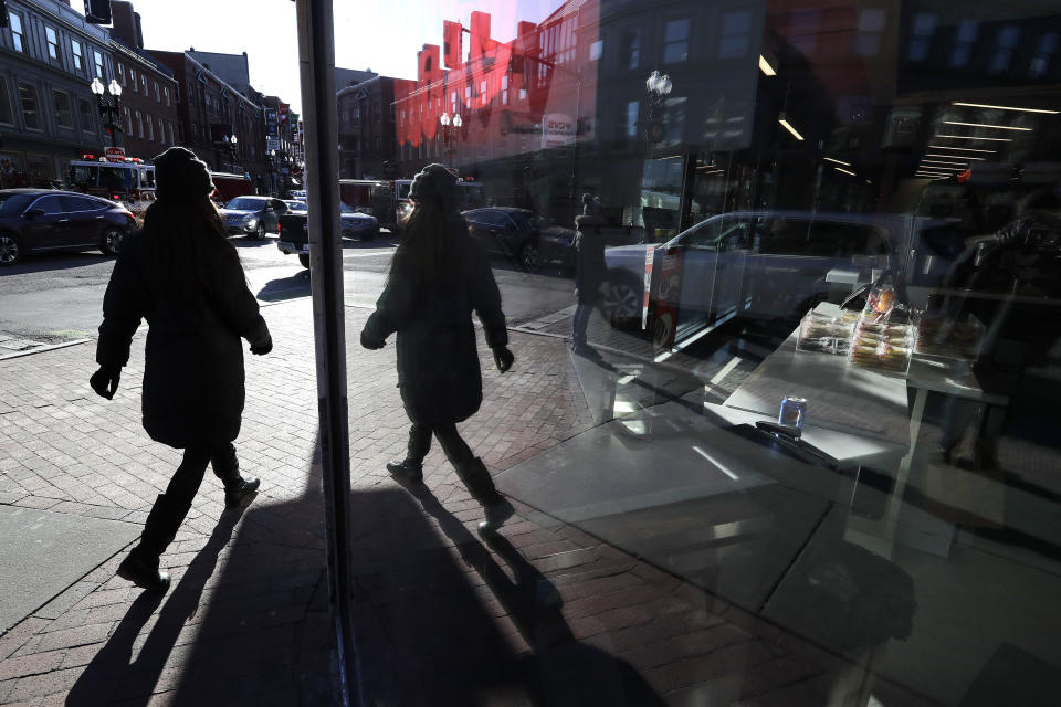 In this Jan. 9, 2020 photo a passer-by is reflected in the glass of a storefront in the Harvard Square neighborhood, of Cambridge, Mass. Recessions, and their severity, are out of your control, but as Luke Delorme, director of financial planning at American Investment Services and others point out, your own financial situation doesn’t have to be. You can take steps to insulate yourself from an economic downturn. (AP Photo/Steven Senne)