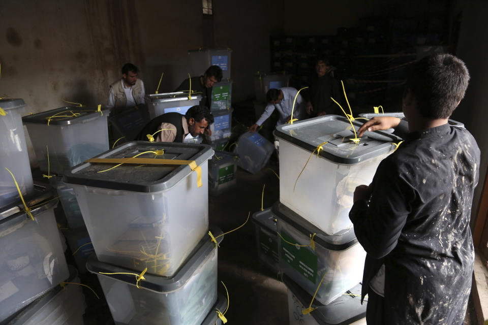 Afghan workers of the election commission office arrange ballot boxes in Jalalabad, east of Kabul, Afghanistan, Sunday, April 6, 2014. Across Afghanistan, voters turned out in droves Saturday to cast ballots in a crucial presidential election. The vote will decide who will replace President Hamid Karzai, who is barred constitutionally from seeking a third term. Partial results are expected as soon as Sunday. (AP photo/Rahmat Gul)