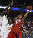 Dayton forward Devin Oliver (5) shoots against Florida center Patric Young (4) during the first half in a regional final game at the NCAA college basketball tournament, Saturday, March 29, 2014, in Memphis, Tenn. (AP Photo/John Bazemore)