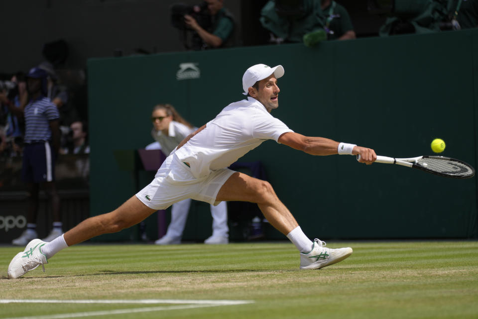 Serbia's Novak Djokovic returns to Australia's Nick Kyrgios during the final of the men's singles on day fourteen of the Wimbledon tennis championships in London, Sunday, July 10, 2022. (AP Photo/Kirsty Wigglesworth)