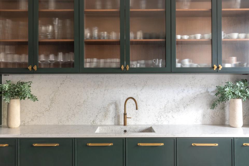 Cabinets with glass display doors will catch the light and open your space (Caesarstone)