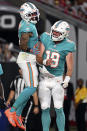 Miami Dolphins wide receiver Lynn Bowden Jr. (3) celebrates with quarterback Skylar Thompson (19) after scoring against the Tampa Bay Buccaneers during the first half of an NFL preseason football game Saturday, Aug. 13, 2022, in Tampa, Fla. (AP Photo/Jason Behnken)
