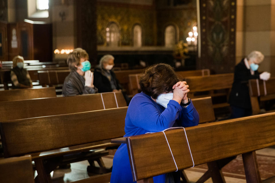 People pray in church in the first day when religious services are allowed again in Turin on May 18, 2020 during the country's lockdown aimed at curbing the spread of the COVID-19 infection, caused by the novel coronavirus. - Generic shops  and churches reopen in Italy on May 18, 2020 as new government disposition easing the lockdown in a cautious, gradual return to normality, allowing businesses and churches to reopen after a two-month lockdown. (Photo by Mauro Ujetto/NurPhoto via Getty Images)