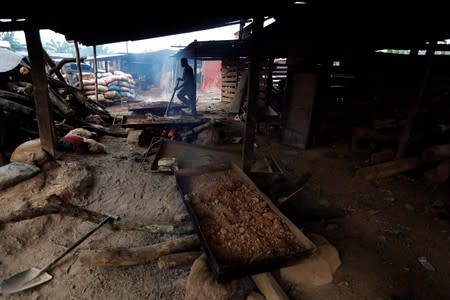 Gold ore is roasted on a fire at the unlicensed mining site of Nsuaem Top in Ghana