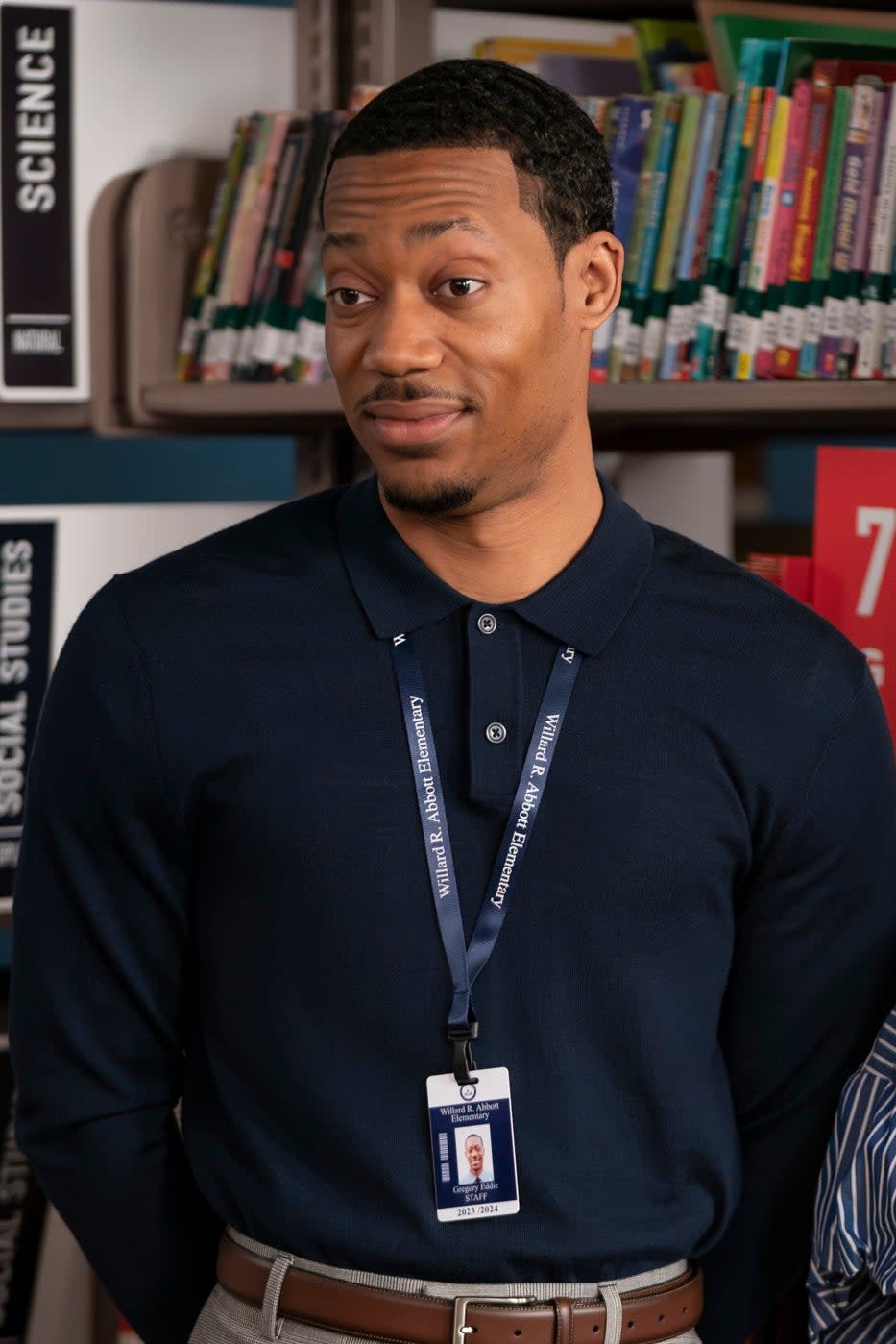 Tyler James Williams and Quinta Brunson stand in a library, smiling and casually dressed, on the set of 