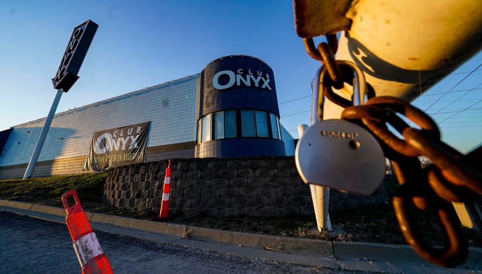 A lock holds the front gates together outside of Club Onyx after the popular strip club was shut down in February following a police raid resulted in drug, alcohol, gun and prostitution charges.