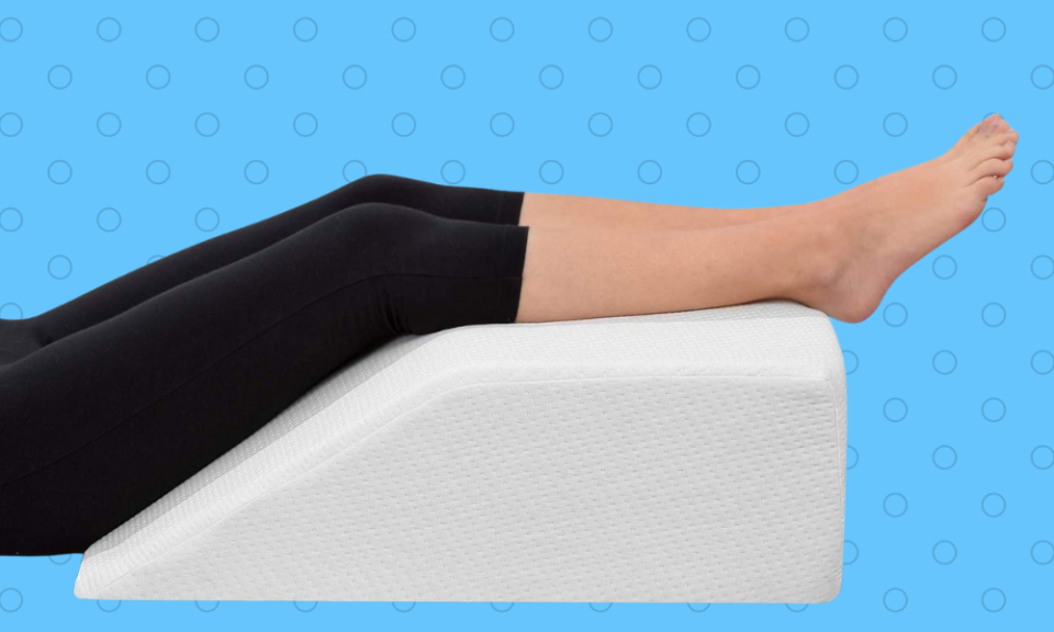 person resting legs on a pillow